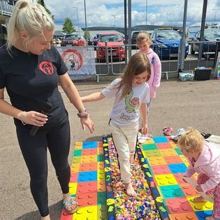 people walking on Lego bricks