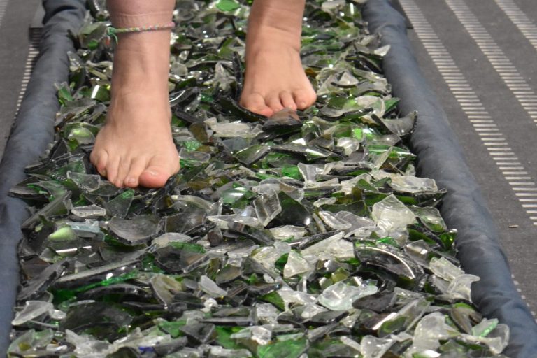 Feet walking on broken glass